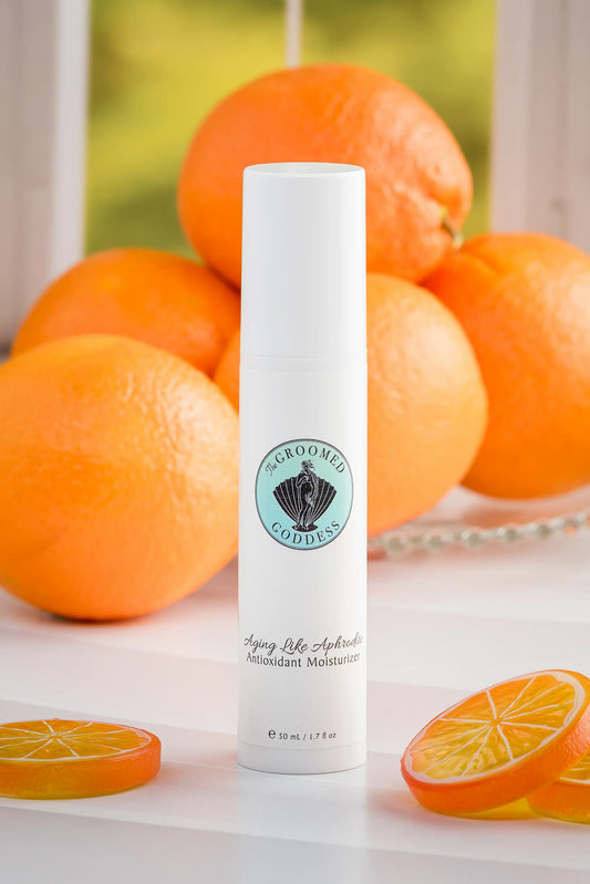 Skincare product with oranges on a white surface - Aging Like Aphrodite Antioxidant Moisturizer