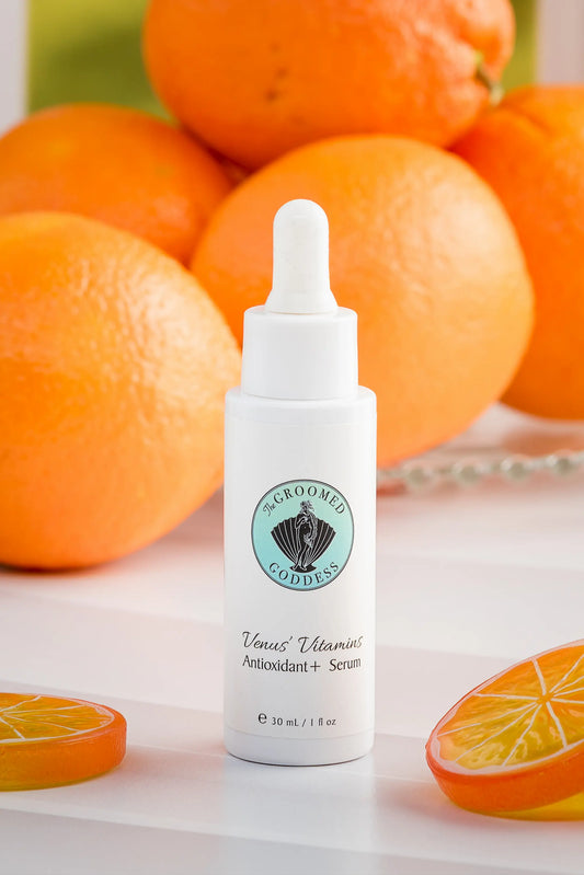 Venus' Vitamins Antioxidant + Serum by The Groomed Goddess - Skincare serum bottle with oranges in the background