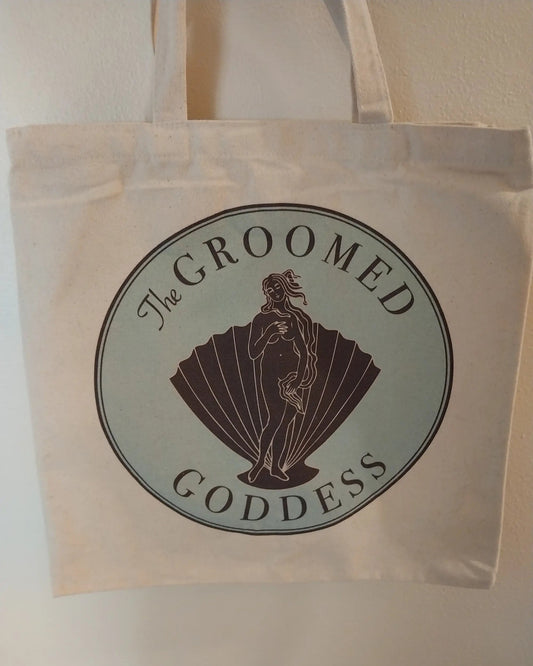 Tote bag with 'The Groomed Goddess' logo on a plain background